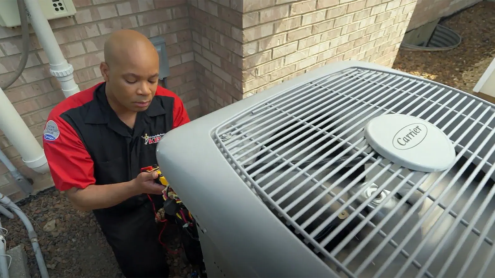 A King technician working on an outdoor AC condenser