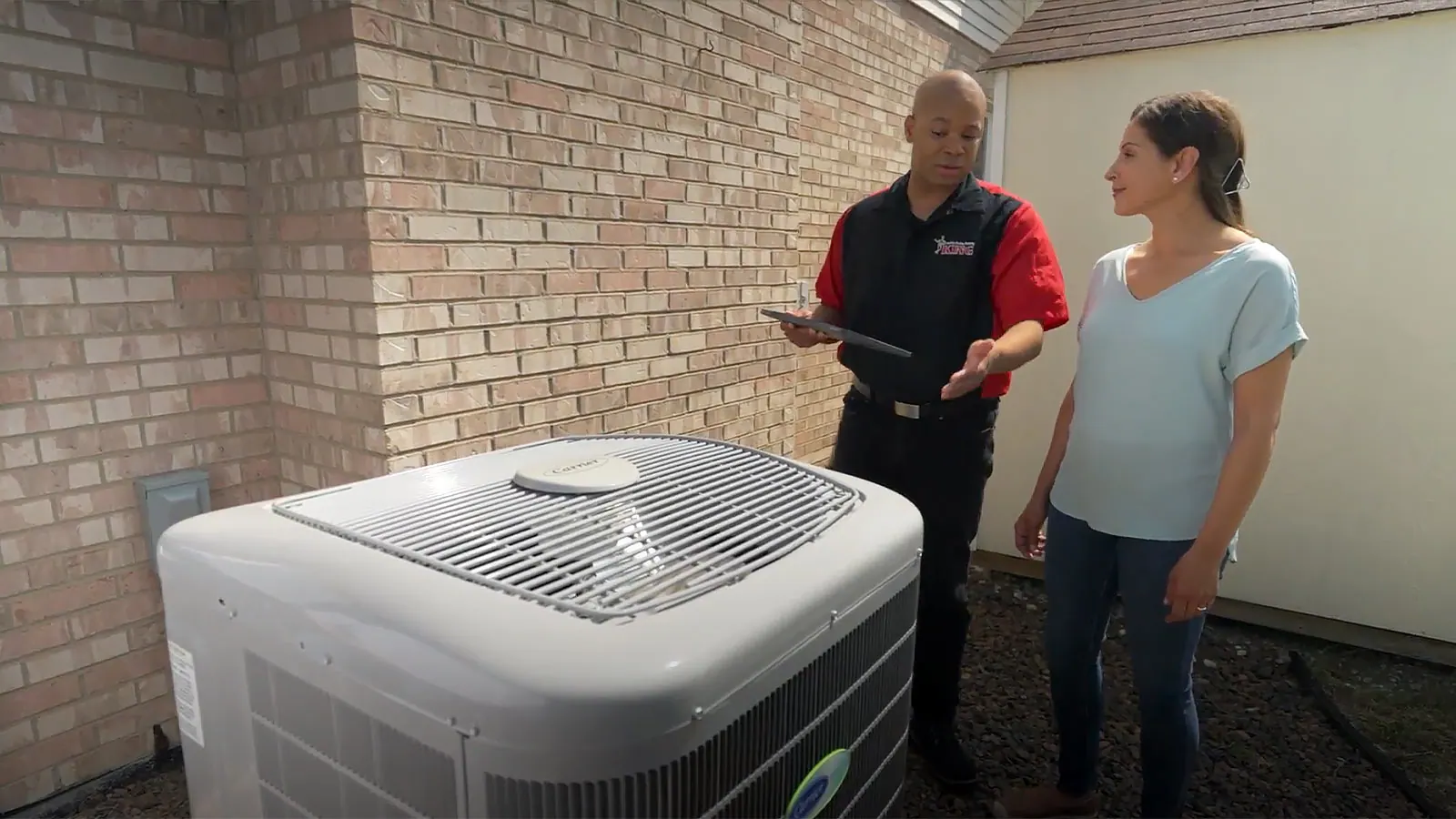 A King technician working on an outdoor AC condenser