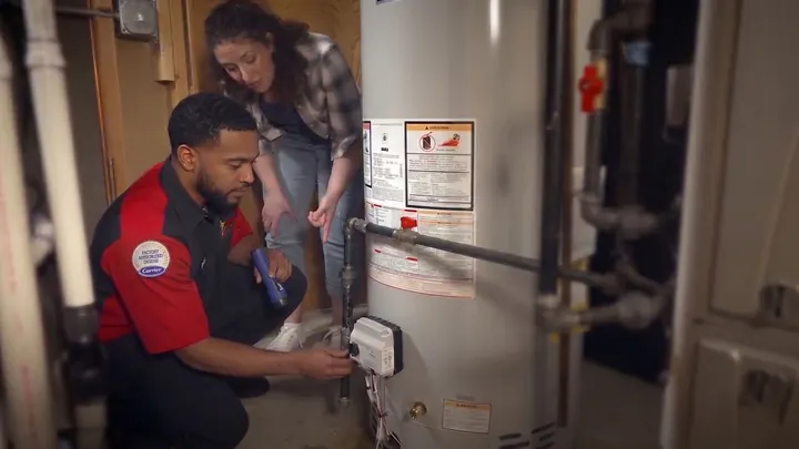 A King plumber working on a tank water heater