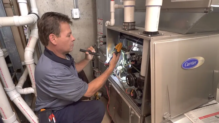 A King technician wiring a new Carrier furnace